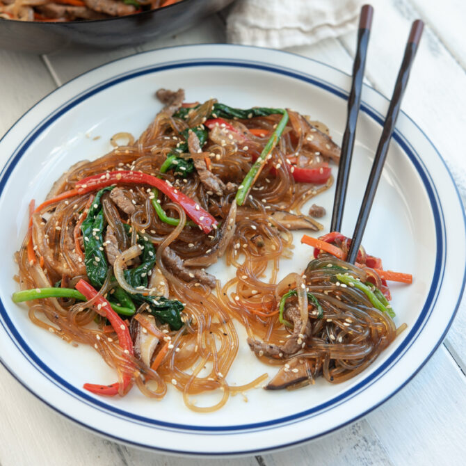 Japchae is Korean glass noodle stir-fry with beef and vegetables