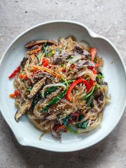Japchae Korean glass noodles with beef and vegetables in a bowl