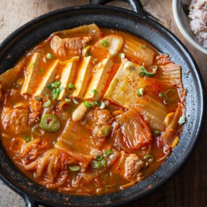 Korean kimchi jjigae with pork tofu and napa cabbage in spicy broth