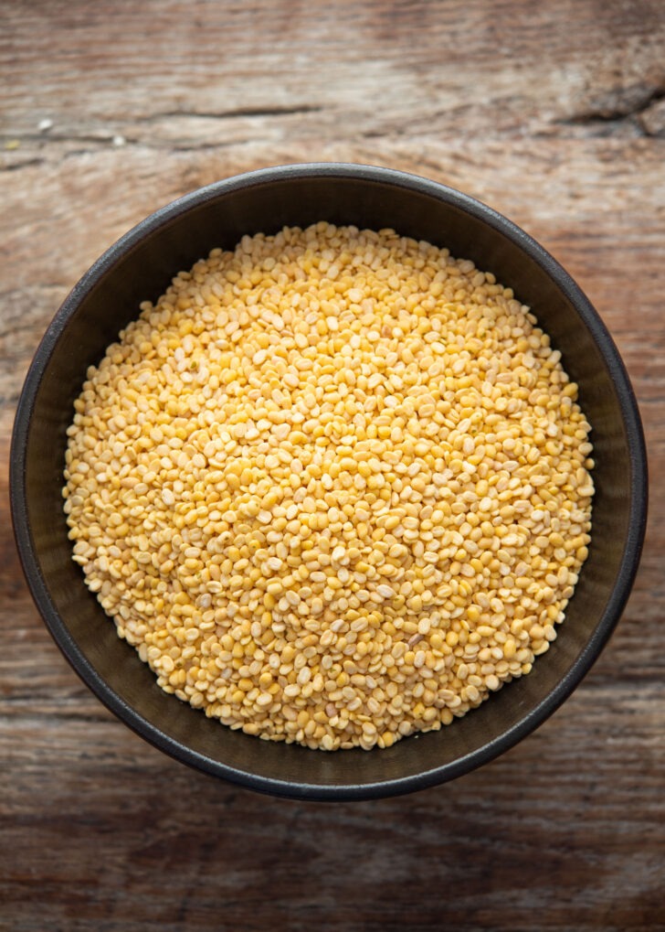 Pre-hulled yellow split mung beans in a bowl for making bindaetteok
