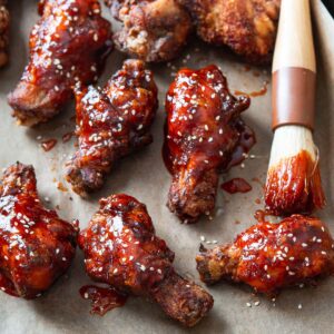 Crispy Korean fried chicken (yangnyeom) glazed with spicy sauce and sesame seeds