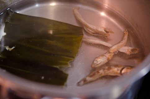 Dried anchovies and a piece of sea kelp is simmering in a pot to make the anchovy stock.