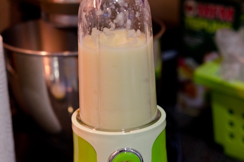 A personal blender is pureeing vegetable mix smoothly.