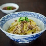 radish and beef rice bowl dish is cooked in a rice cooker and served with sauce