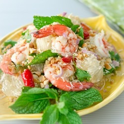 Fresh pomelo fruit with poached prawn salad is served with mint leaves