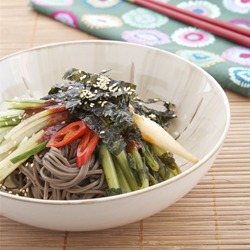 Cold Buckwheat Noodles are topped with kimchi and seaweedwith Chili Sauce