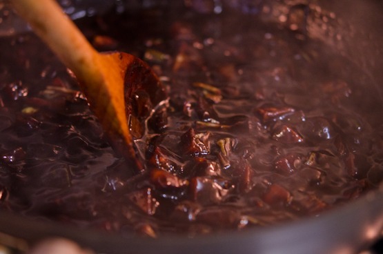 Korean Jjajangmyun sauce is thickening with stirred by a wooden spoon.