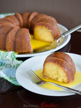 A slice of orange cake is served with luscious orange sauce.