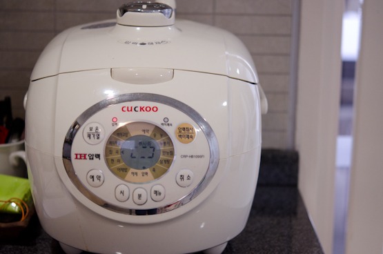 Electric rice cooker is powered on to cook.