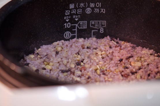 Electric rice cooker showing the cooked multigrain rice (japgokbap).