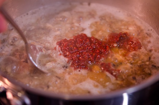 Seasoning paste is added to the fish topping mixture.