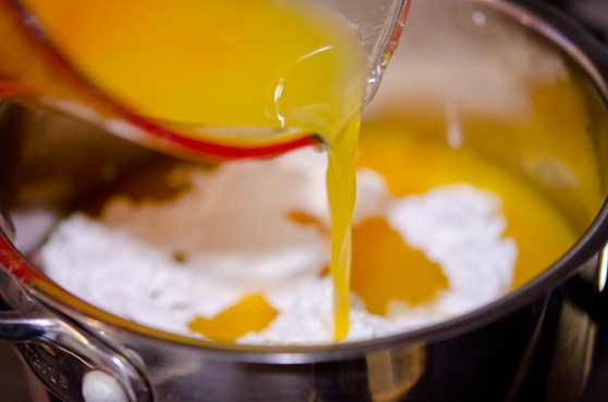 Fresh squeeze orange juice is added to sugar and lemon juice in a pan.