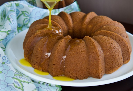 Lucious orange sauce is poured over orange cake.