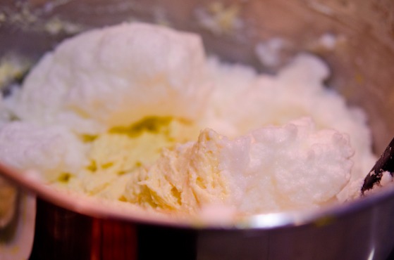 Beaten egg whites are folded into orange cake batter.