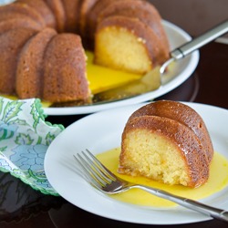 A slice of orange cake is served with luscious orange sauce.