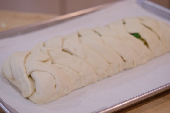 Stromboli is well braided and placed on a baking sheet.