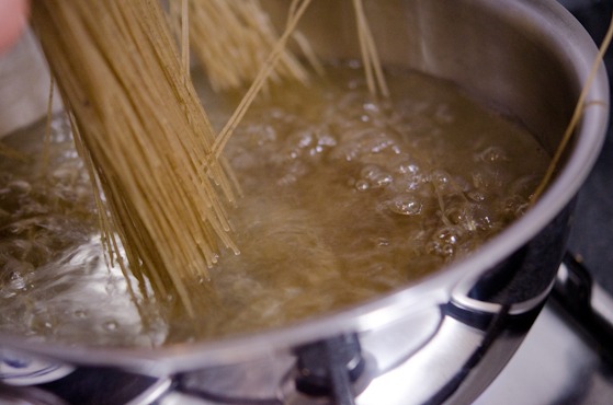 Nangmyeon noodles are added to a boiling water in a pot.