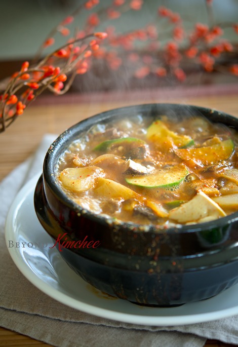 Beef donajng jjigae is boiling in a Korean stone pot.
