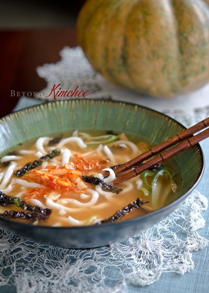 Kimchi Udon is served with a pieces of roasted seaweed.