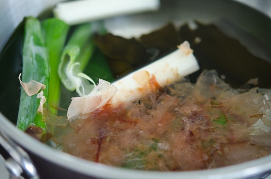 Bonito flakes, leek, sea kelp is combined with water to make a stock for udon.