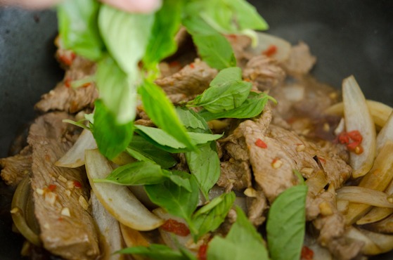 Thai basil leavers are added to the beef stir-fry.