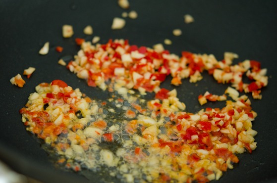 Chili and garlic mixture is stir-fried together.