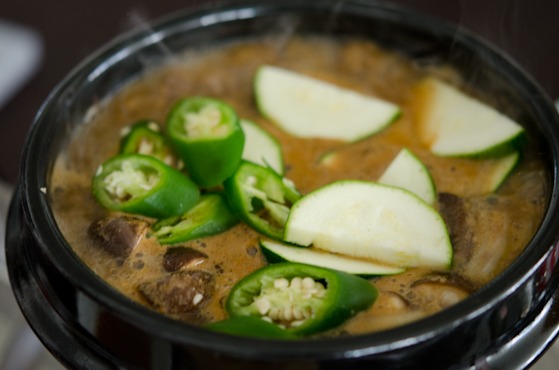 Zucchini and fresh chili are added to Korean soybean paste stew.