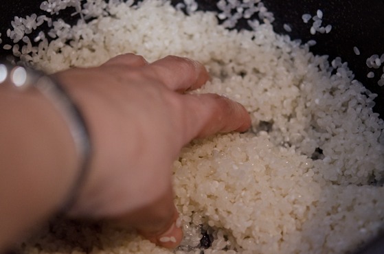 Swirl around the rice with fingers to remove the starch coating.