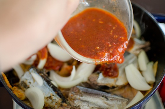 Chili seasoning is added to kimchi mixture to make kimchi stew.