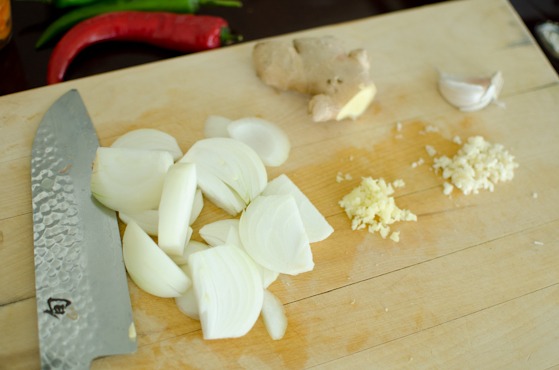 Thinly sliced onion, garlic, and ginger is prepped for making a Korean dish.