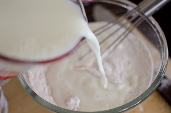 Milk is poured onto a dry ingredient mixture.