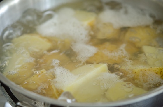 Potato pieces are boiling in a pot