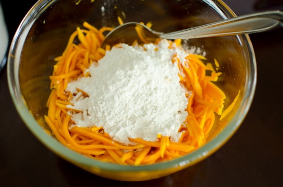 Flour is added to pumpkin slices to make Korean pumpkin pancakes.