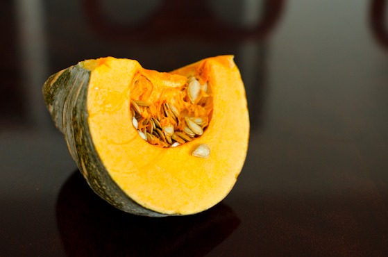 A chunk of sliced fall pumpkin is placed on a table