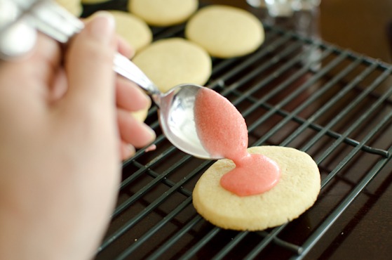 Drizzle fresh strawberry icing on the cooled sugar cookies to decorate.