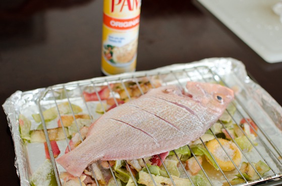 Red Snapper is placed on a rack over frozen vegetables and fruit rinds