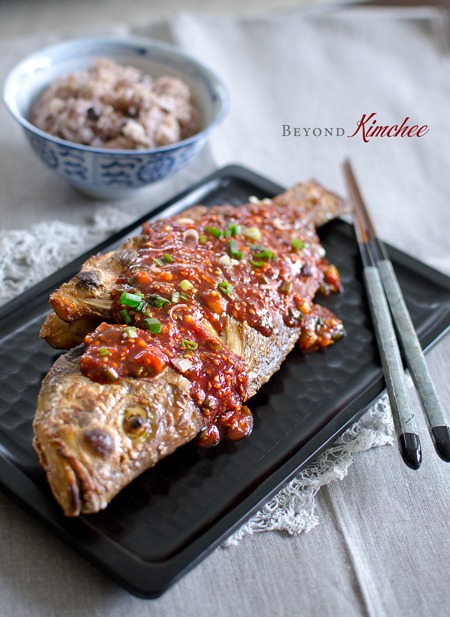 Broiled red snapper is topped with spicy Korean chili sauce to serve with rice.