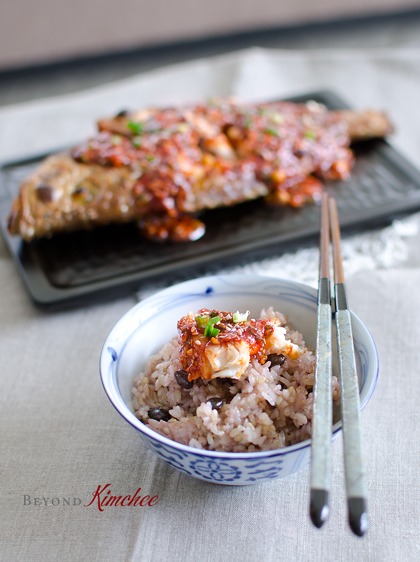 Broiled red snapper with Korean chili sauce is served with rice.