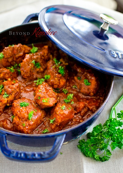 Cape Malay chicken curry is garnished with parsley in a blue pot with a lid