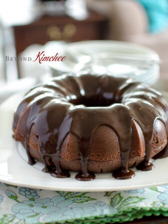 Chocolate Sour Cream Bundt Cake is drizzled with chocolate ganache.