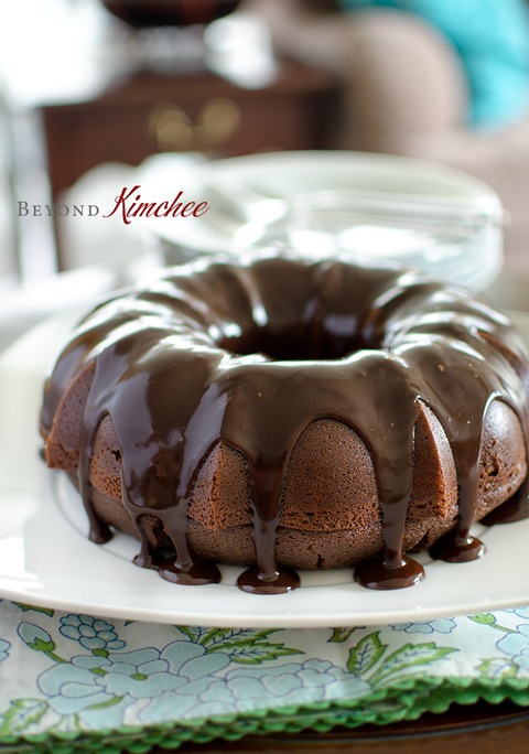 Chocolate Sour Cream Bundt Cake is drizzled with chocolate ganache.