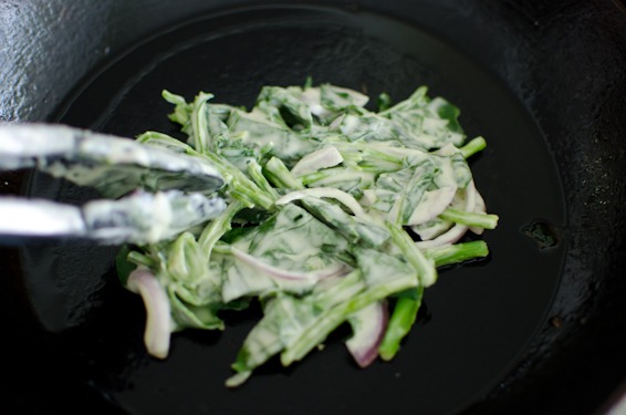 Spread a small amount of spinach pancake batter thinly on a hot skillet.