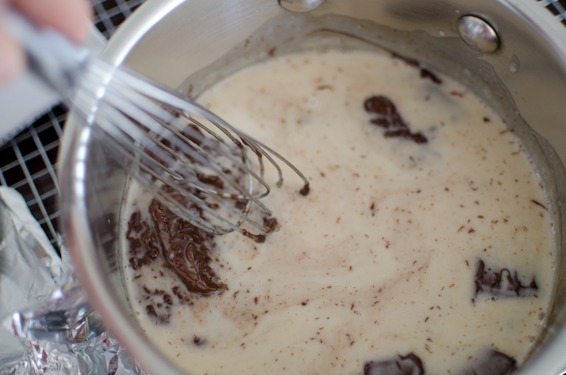 Let the chocolate melt in the cream mixture and whisk together.