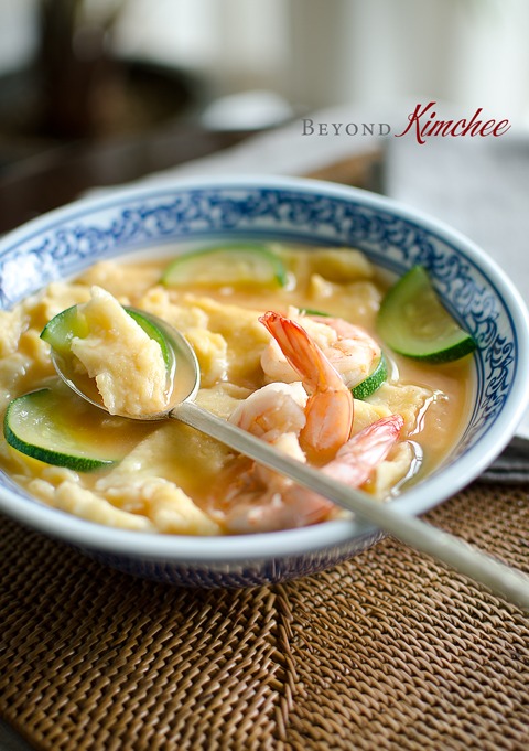 Corn Dumpling, shrimp, and zucchini are cooked in a soybean paste broth.