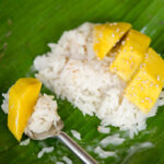 Mango sticky rice on a banana leaf.