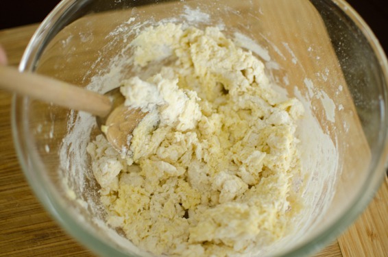 Mix the corn dumpling dough with a wooden spoon.