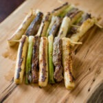 Beef, rice cake, and green onion are skewered together and pan-fried.