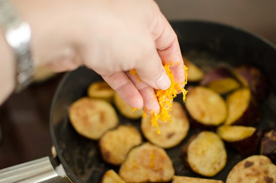 Sprinkle orange zest over the caramelized sweet potato to add flavor.