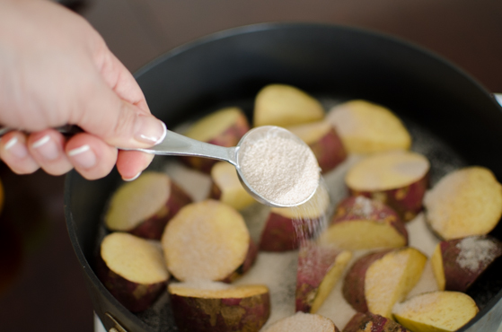 Add the cinnamon sugar over the sweet potatoes in a skillet.