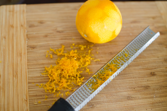 Zest an orange with a zester tool